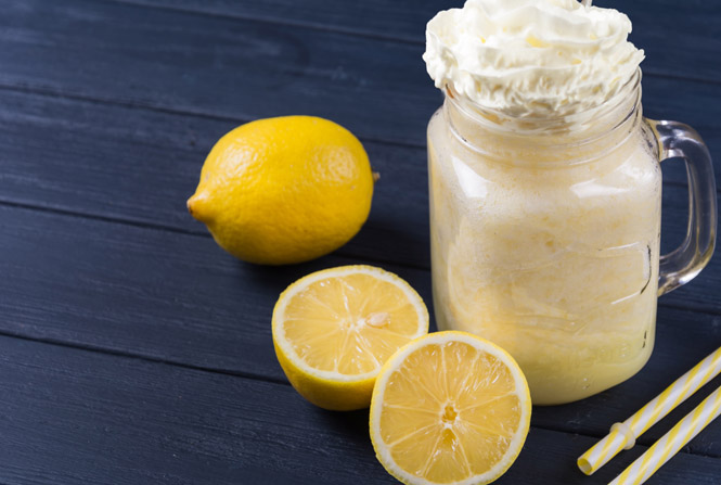 Mason jar filled with frozen lemonade and whipped cream.