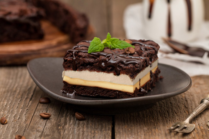 Ice cream, peanut butter, and chocolate chips in the middle of two brownies.